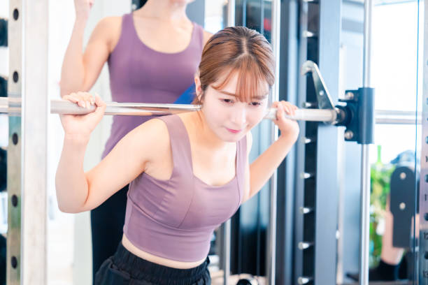 istock Woman undergoing personal training with a female coach at a gym 2206609924