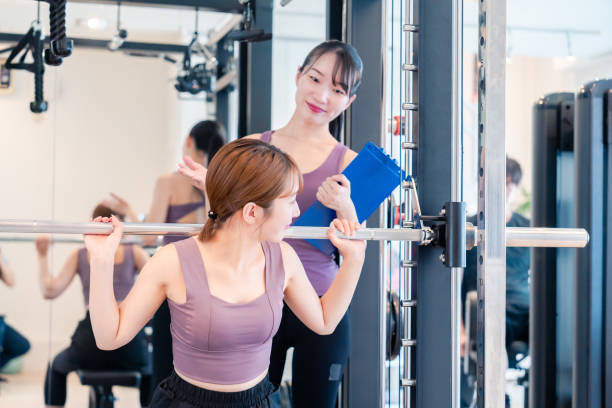 istock Woman undergoing personal training with a female coach at a gym 2206609925