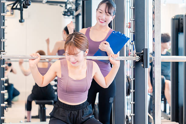 istock Woman undergoing personal training with a female coach at a gym 2206609928