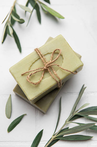 istock Natural olive soap bars tied with twine on white tile background 2206610576