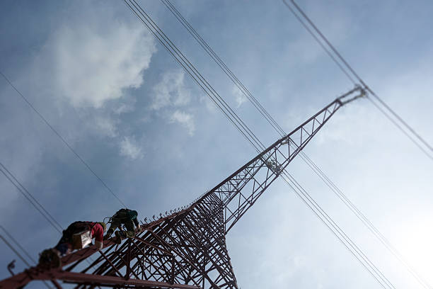 Telecommunication tower antenna at blue cloudy sky
