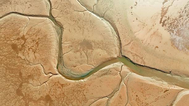istock Aerial view of cracked earth and stream. 2206611547