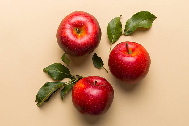 istock Many red apples on colored background, top view. Autumn pattern with fresh apple above view with copy space for design or text 2206612576