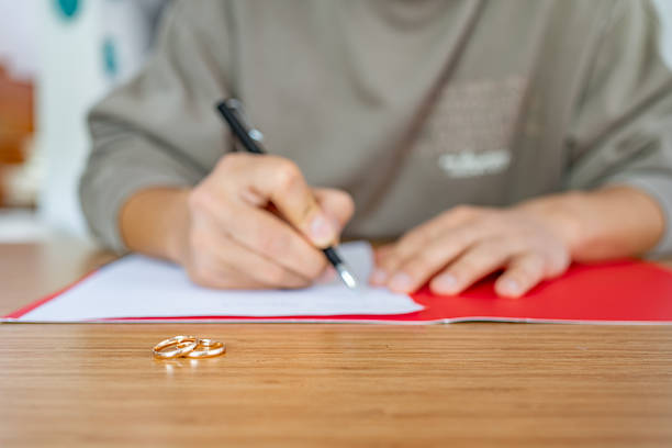 A touching moment of a couple formalizing their marriage with signatures during a ceremony, symbolizing their union.