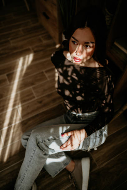 Young people concept - woman legs in denim trousers dancing, girl relaxing at home