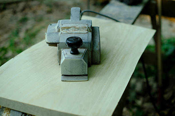 Electric hand planer on wood in vintage carpentry setting