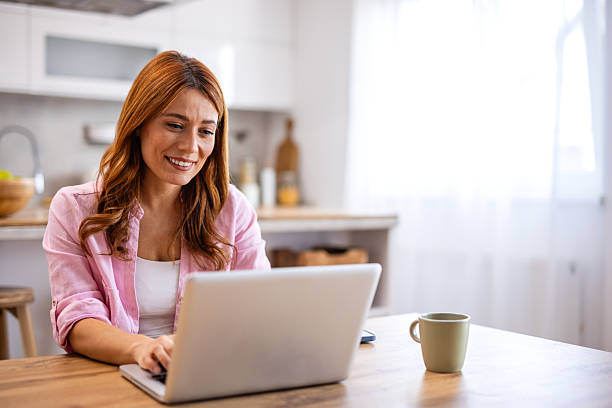 istock Beautiful woman freelancer noting information for planning project doing remote job via laptop computer. woman reading email on modern laptop device 2206617436