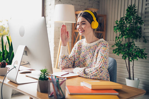 istock Young woman engaging in online communication at home, smiling and interacting 2206618626