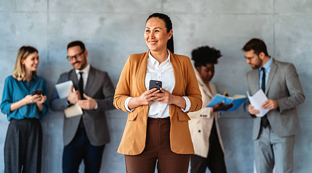 istock Happy businesspeople laughing while collaborating on a new project in an office. 2206619726