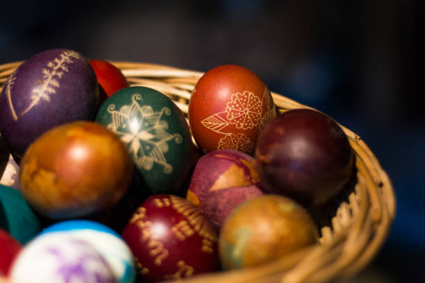 istock Colorful hand-painted Easter eggs in little basket 2206621384