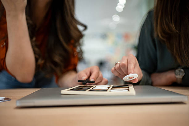 istock Designers playing tic-tac-toe with customized pieces during a break 2206622185