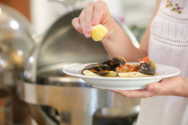 Woman taking food from a buffet line
