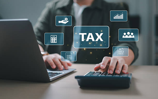 istock Businessman calculating budget, data analysis, documents, reports, tax refund calculation, tax calculation with calculator and laptop. 2206624913