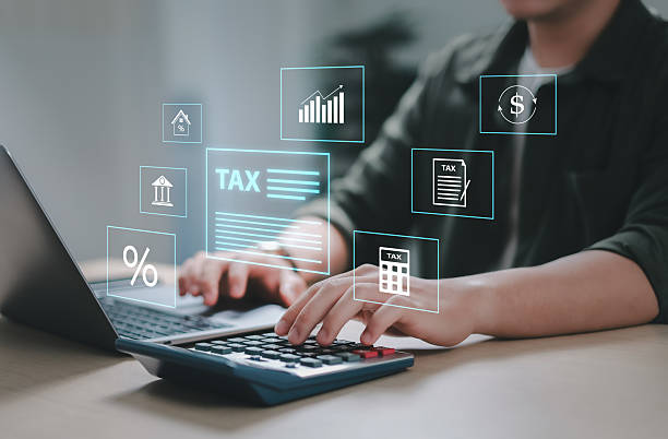 istock Businessman calculating budget, data analysis, documents, reports, tax refund calculation, tax calculation with calculator and laptop. 2206624916