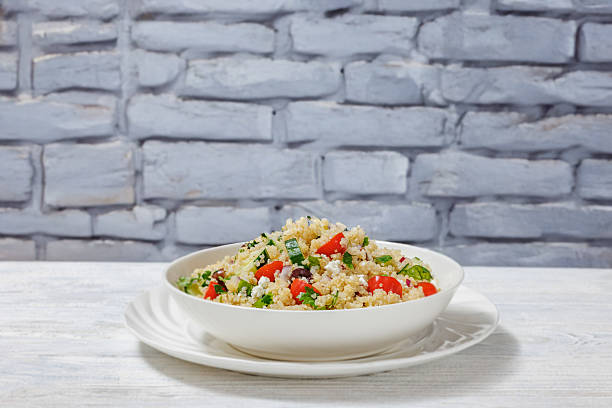 istock quinoa salad with veggies, cheese, olives in bowl 2206626568