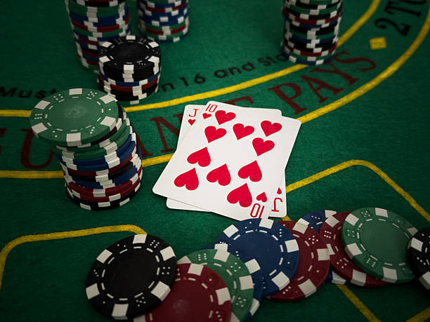 istock poker chips and cards on the green table background 2206627297