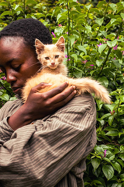 istock A young black woman standing outdoors with a kitten perched on her shoulder 2206628240