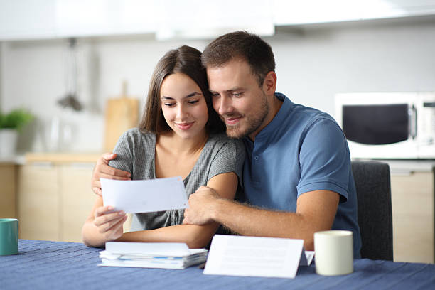 istock Couple at home cheking together bank statement 2206629435