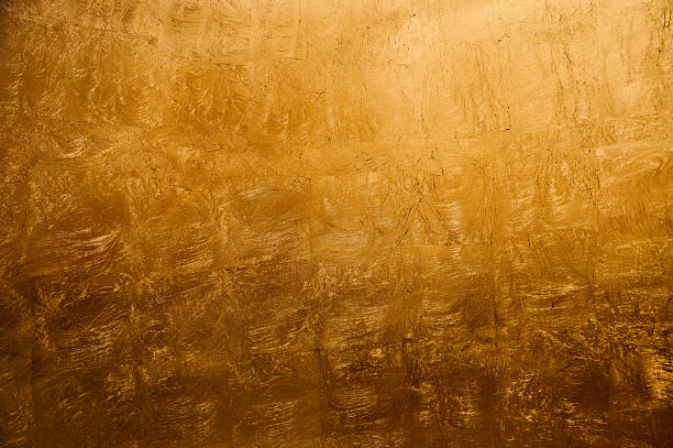 istock Golden textured surface with abstract patterns created by light and shadow in a vibrant setting 2206630692