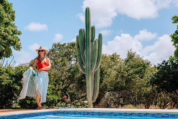 istock Woman in Sun Hat by Poolside with Towel 2206630787