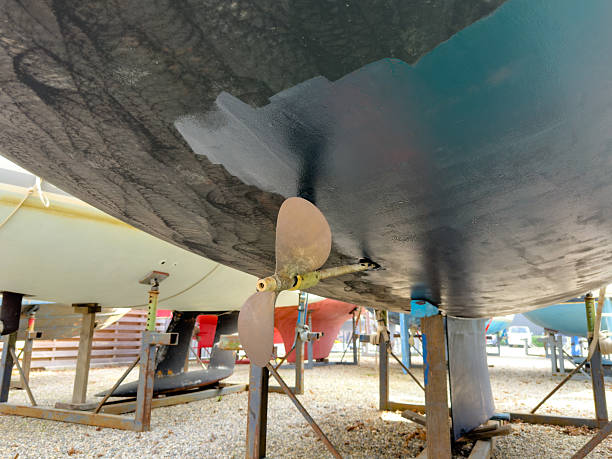 istock Sailing boat on stilts being painted with antifouling in boatyard 2206630815