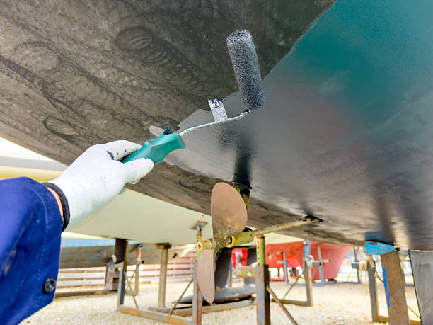 istock Sailing boat on stilts being painted with antifouling in boatyard 2206630819