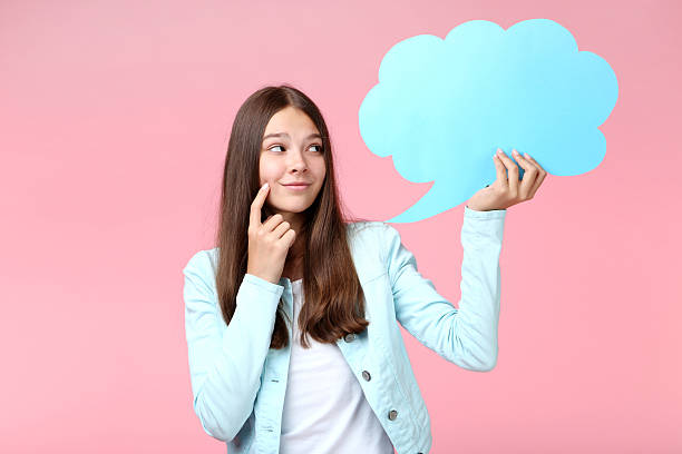 istock Young girl with speech bubble on pink background 2206633031