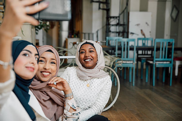 istock Three friends talking together sitting on the sofa at home and shoot a selfie 2206633044