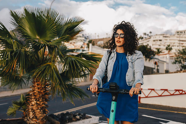 istock Young woman riding an electric scooter 2206633426