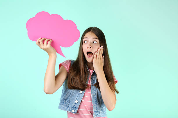 istock Young girl with speech bubble on mint background 2206633635
