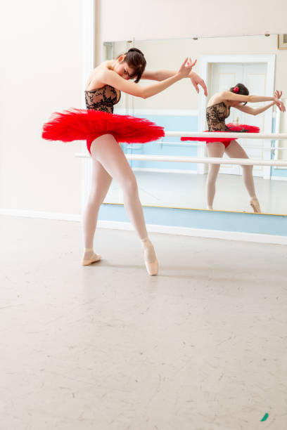 Portrait of teenage girl ballet dancer smiling at the dance studio