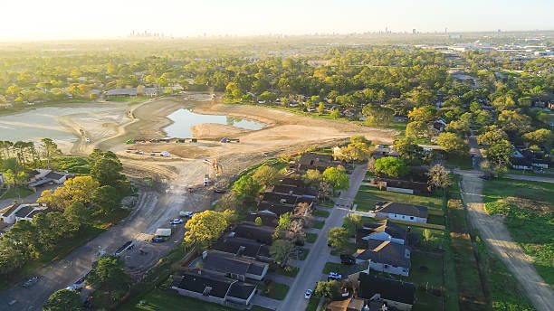 istock Heavy equipment, dump trucks, cranes at construction site stormwater detention basins to provide flood damage reduction during heavy storm Antoine Dr, Inwood Forest golf course in North Houston 2206638043