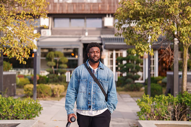 istock Young Black Man Walking Through the City 2206639175