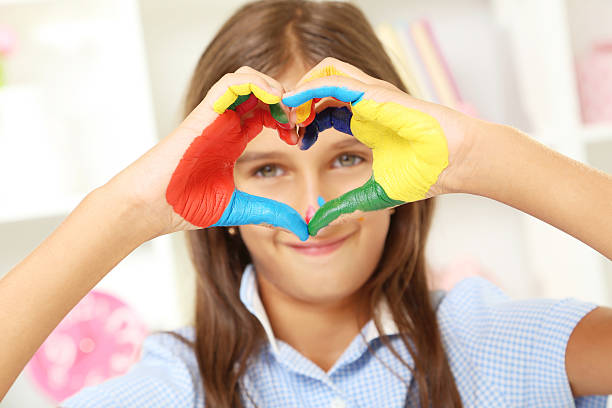 istock Beautiful little girl with painted hands 2206639469