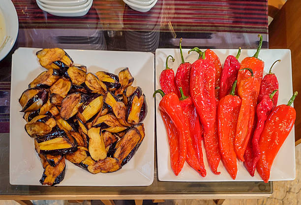 Delicious and healthy grilled vegetable salad with eggplant, red peppers, and fresh herbs, seasoned with aromatic spices