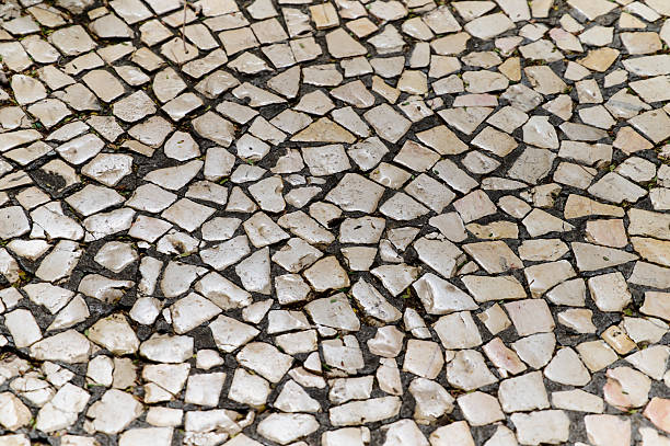 Mosaic floor showcases an intricate arrangement of stone pieces, revealing a blend of colors and shapes.
