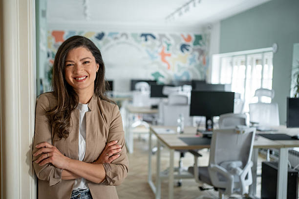 istock Confident businesswoman smiling in modern office environment 2206644701