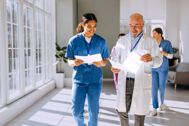 istock Two doctors walking and discussing a medical record 2206645203