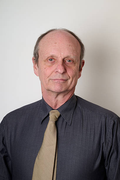 istock Senior man with a cotton shirt against white wall 2206646555