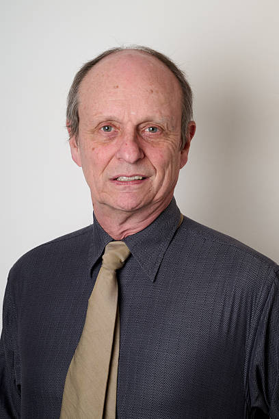 istock Senior man with a cotton shirt against white wall 2206646565