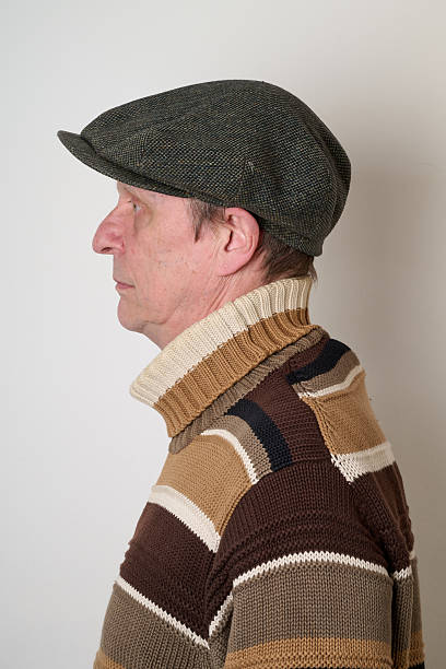 istock Senior man with a beige turtleneck puulover and a vintage cap 2206646577