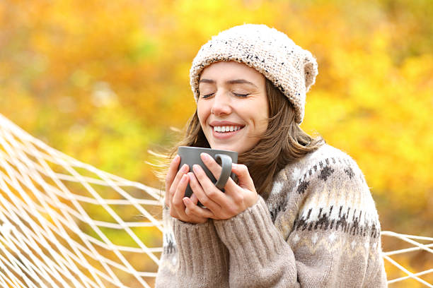 istock Woman in autumn in a forest enjoying drinking coffee 2206648372