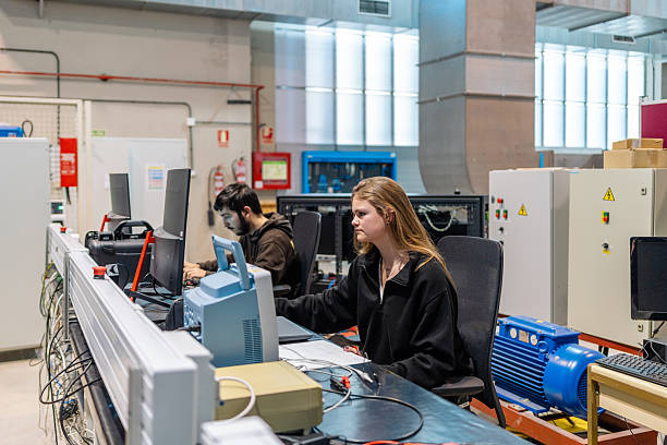istock Two young adult engineering students concentrating on their computer work in a university laboratory 2206649795