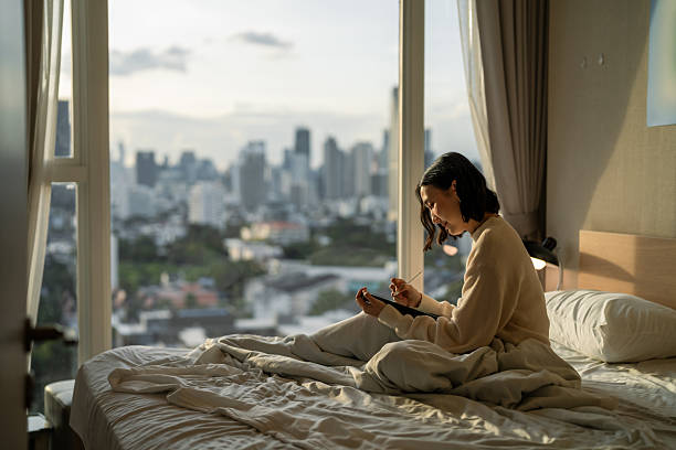 istock Asain woman writing her to-do list on digital tablet 2206651168
