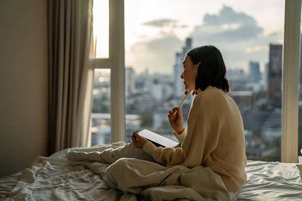 istock Asain woman writing her to-do list on digital tablet 2206651252