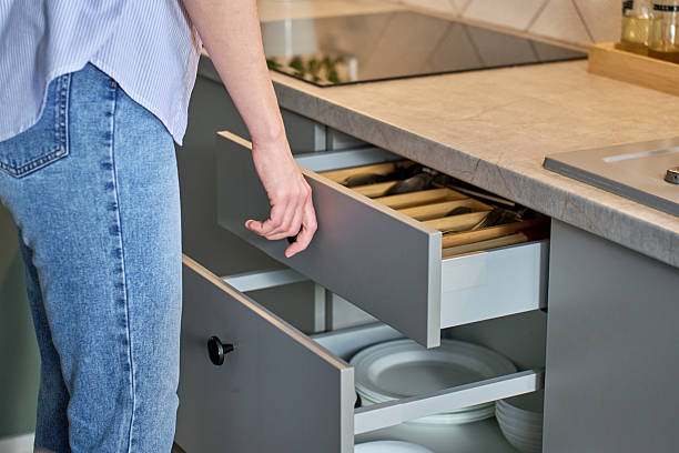 istock Person opening kitchen drawer with cutlery in cabinet 2206651497
