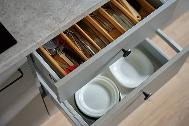 istock Modern kitchen cabinets with dishes and cutlery in open drawers 2206651499