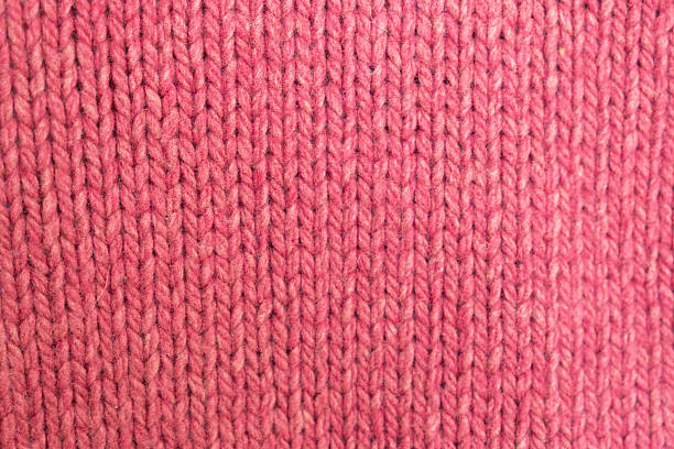 istock knitted texture, pink fuchsia sweater or carpet, pattern of back loops and front. 2206652643
