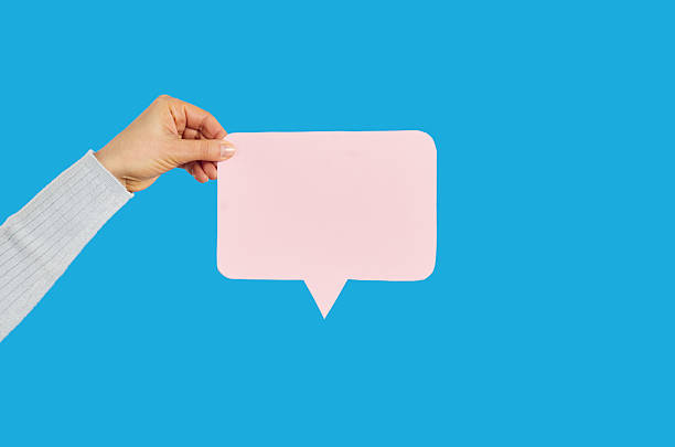 istock Hand showing blank speech bubble, straight cutting shape, on blue studio background. 2206652760