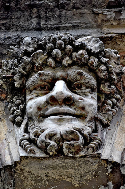 istock Bacchus relief sculpture on a weathered building facad 2206654124